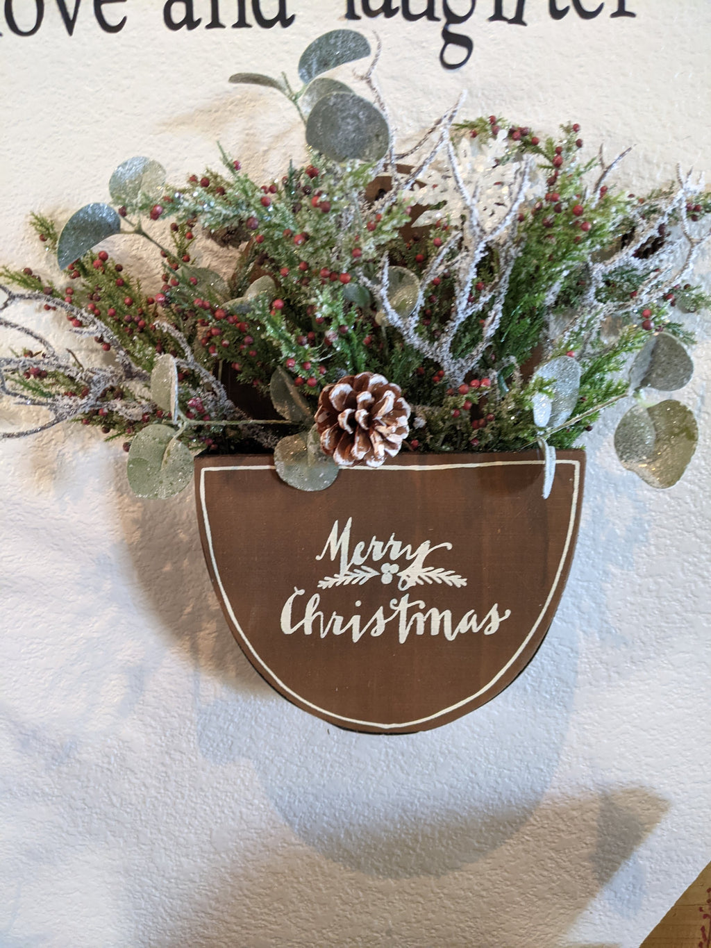 Handmade wooden merry Christmas box with winter greenery and berries
