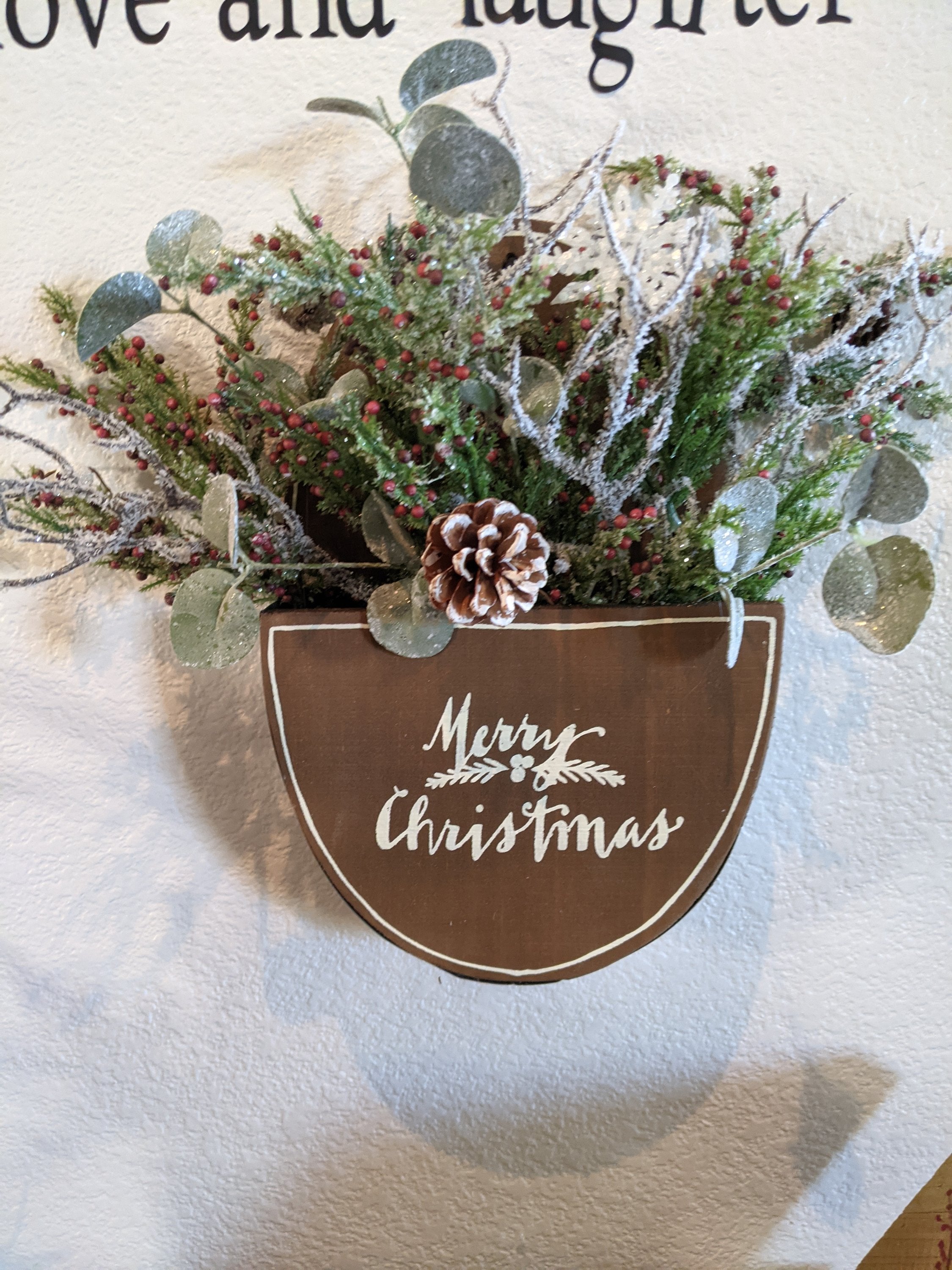 Handmade wooden merry Christmas box with winter greenery and berries
