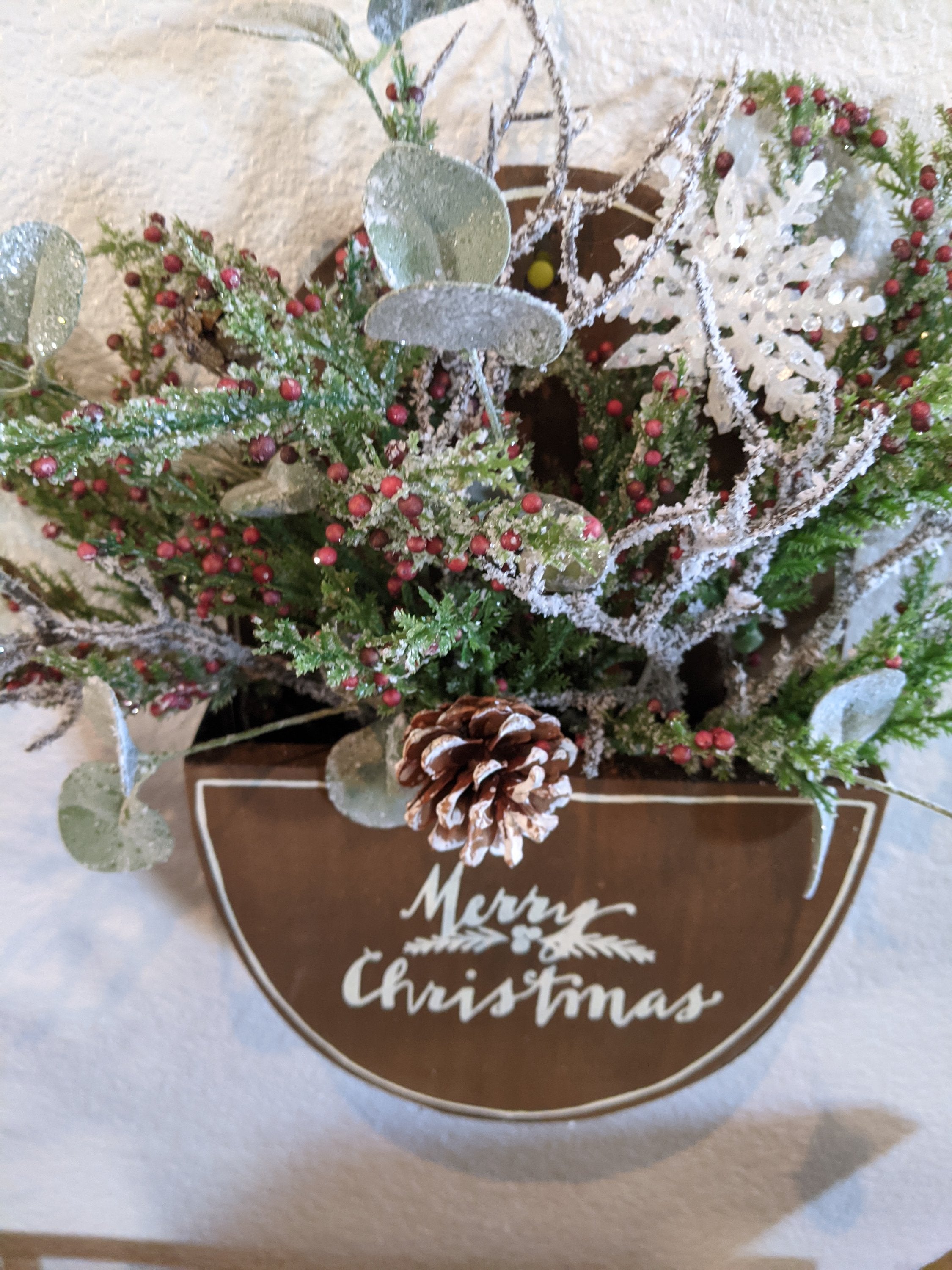 Handmade wooden merry Christmas box with winter greenery and berries