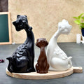 Elegant Trio of Cat Figurines in Black, Brown, and White