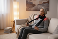 Older Woman on Couch with Long Black Neck Massager